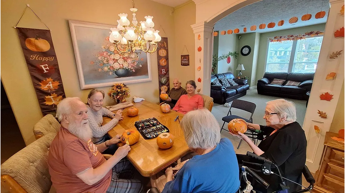 residents in senior care home in Vancouver WA painting a pumpkin