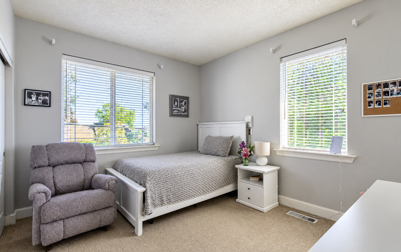 Bright bedroom with white bed and flowers
