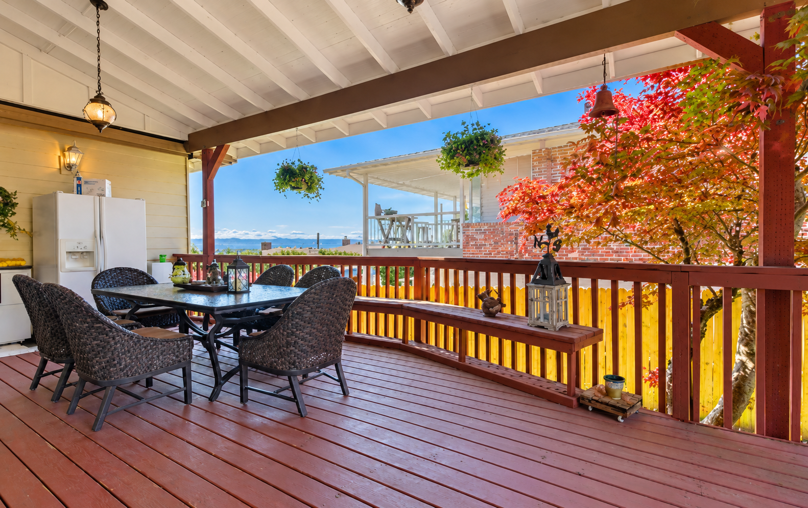 Brightened covered deck with autumn maple